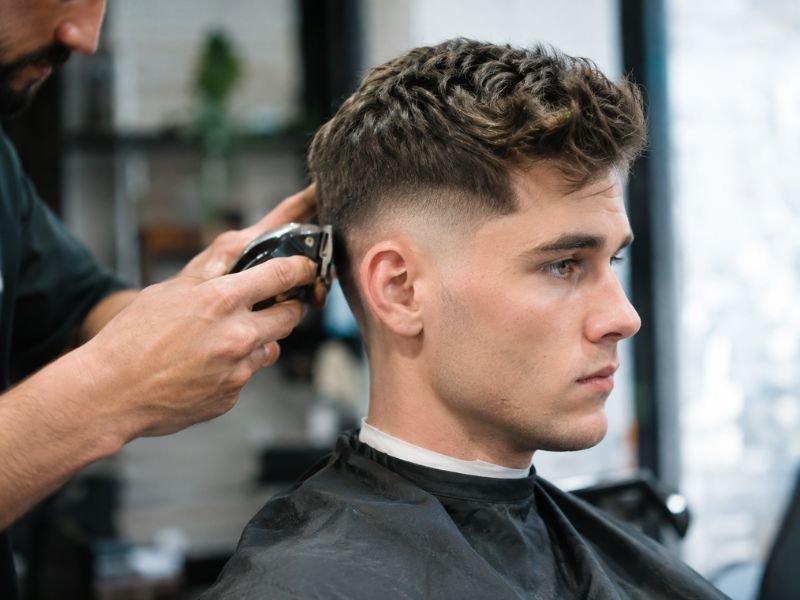 Barber maintaining a low taper fade haircut