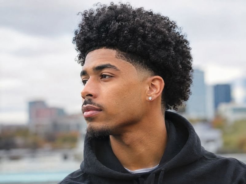 Low taper fade with afro hairstyle