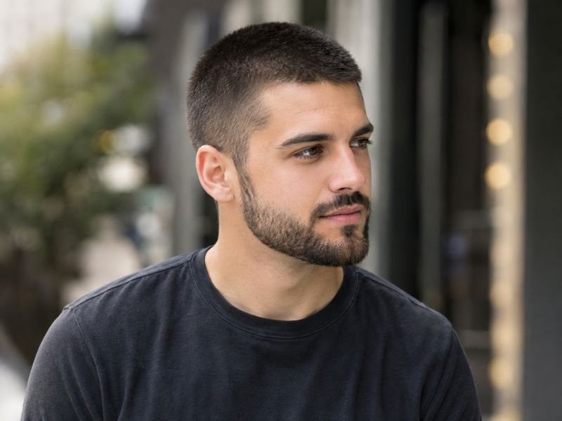 Man with an 8 guard buzz cut paired with a short beard
